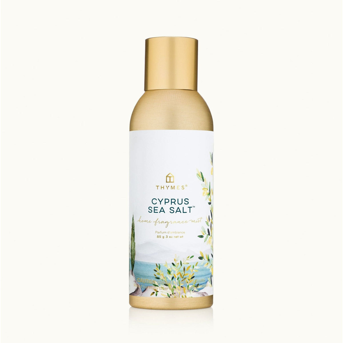 A bottle of Thymus Cyprus Sea Salt body lip balm with a metallic gold cap and a white label featuring a blue sea and green floral illustration, set against a solid off-white background.